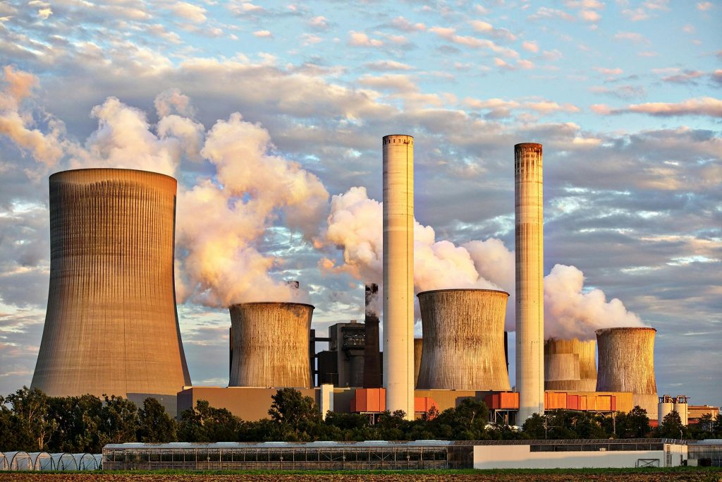 pexels photo 459728 459728 View of a power plant with smoke emissions under a cloudy sky, depicting industrial energy production.